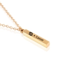 Macro detail of golden Cancer zodiac pillar pendant with engraving on cross chain - Gold Cancer