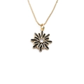 Close-up of golden chain necklace featuring a black daisy pendant with a clear center gem - Black
