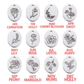 Polished stainless steel oval birthday flower pendants for 12 months in a grid layout - October-Marigold / Steel