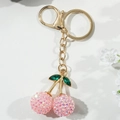 Pink gemstone cherry keychain with gold metal plating and green leaf accents - Pink Faceted Gemstone Style (KC2019)