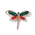 Close-up of a gold-plated dragonfly brooch with vibrant red and green crystal wings - Style 3