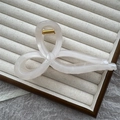 Pearlescent beige jelly hair claw clip in a twist design on a velvet display tray - 13cm Ribbon Bow / Jelly White