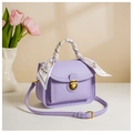 Detail of purple PU leather handbag with silk scarf accessory and gold hardware - Purple