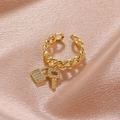 Golden Cuban chain open ring featuring micro-pave lock and key charms on silk background - Gold-Tone Cuban Chain Open Ring with Lock and Key Charms