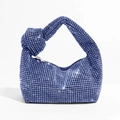 Detail shot of blue rhinestone knot handbag showing sparkling gems and twisted handle - Blue