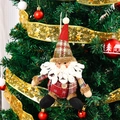 Primer plano del adorno de Papá Noel de tela a cuadros en un árbol de Navidad festivo - Papá Noel