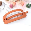 Matte orange oval cutout hair clip on a minimalist pink plaid background - Orange