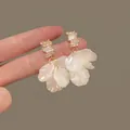 Handheld cream shell flower earrings with square crystals and golden metal studs - Tassel Shell Flower Earrings