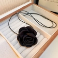 Detail of a black fabric rose pendant necklace placed inside a wooden jewelry gift box - Necklace-Black (Large)