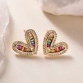 18K gold plated heart stud earrings with sparkling zircon stones on a beige surface - Gold Multi-Colored Zirconia (45530)