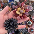 Detail showing handcrafted polished semi-precious stone tumbled flower ornaments in diverse colors - Obsidian