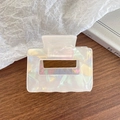 Iridescent white square hair claw clip with pearl mermaid finish on a wooden table - White