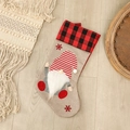 Christmas stocking featuring red black plaid cuff and festive gnome on beige linen - Striped