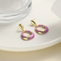 Detailed view of elegant purple enamel earrings with golden twisted metal on ceramic - Purple