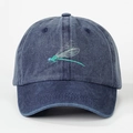 Fashionable washed denim baseball cap featuring an embroidered dragonfly in green and white - One Size / Navy Blue