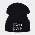 Close-up of black knit beanie with white DOG DAD embroidery and paw print detail - DOG DAD / Black