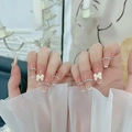 Macro detail of French tip press-on nails with 3D bows and rhinestone accents - Classic French Bowknot Rhinestone (N5032)