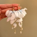 Detailed view of elegant light blue fabric flower dangling earrings with pearls and crystals - Silver Post Gold Flower Style / Blue