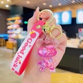 Rosa Bär-Schlüsselanhänger mit Treibsand-Effekt und Silikonarmband mit Good Luck Aufdruck - Rosenroter Treibsand Bär