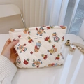 Close-up of quilted cotton makeup bag featuring vintage floral prints and zip closure - Large Cosmetic Bag
