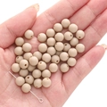 Matte beige acrylic round beads for DIY jewelry making shown held in hand - Milk Tea