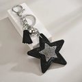 Detailed view of a black rhinestone star keychain with velvet tassels and metal hardware - Black