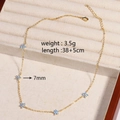 Chic gold necklace with five blue crystal flowers displayed on a beige jewelry tray - Blue Flower - Gold