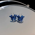 Macro shot of silver butterfly earrings with marquise-cut deep blue zircon stones - 56# Zircon Butterfly Stud Earrings with Silver Needle