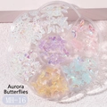 Detailed view of aurora resin butterfly nail charms in a clear hexagonal organizer box - MH-16 Aurora Butterfly