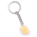 Close-up of semi-transparent amber resin keychain with polished silver metal ring - Citrine