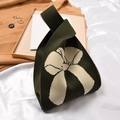 Dark green knitted knot bag featuring a large cream bow jacquard pattern - Army Green Bow