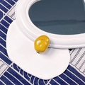 Realistic yellow potato shaped hair clip with glossy finish and realistic brown spots - Potato