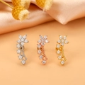 Detailed macro view of three star-shaped zircon ear studs in silver, gold, and rose gold finishes - Style 3