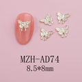 Detail of 8.5x8mm hollow gold butterfly nail art charm with miniature rhinestones on pink tips - Gold Grained Butterfly (AD74)