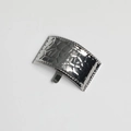 Detail of silver ponytail hair hook with hammered texture and beaded edges on white background - Silver