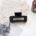 Detailed macro view of a matte black rectangular hair claw clip on a textured white woven mat - Medium Matte Square Claw-Black