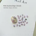 Macro shot of 3x4mm pink oval flatback nail art zircons on a white display card - Pink Oval 3x4 (XY-1010)