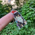 Detail of clear acrylic Sheltie keychain with Christmas hat and colorful lights - Christmas Sheltie with Hat (Style 6)