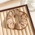 Beige floral corduroy scrunchie with brown lace trim on a jewelry display tray - Edged Khaki