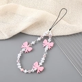 Bijou de téléphone avec nœuds roses et perles blanches sur dragonne noire - Style cœur 3 nœuds rose (K3177)
