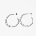 Macro shot of silver irregular hoop earrings with smooth polished metallic finish - Silver (PDE1792)