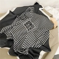 Detail of silk satin scarf with black geometric stripes and HOME text on wool coat - Black Stripe