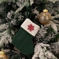 Green cable-knit Christmas stocking with white cuff and red snowflake embroidery hanging - Green/Snowflake