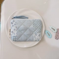 Detail of quilted cotton floral coin purse with blue checkered patterns and zip tie - Blue Plaid Floral