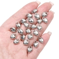 Close-up of heart-shaped silver DIY pendants held in hand to show scale and polish - Small Smooth Heart (8x10mm) / 20 Pcs/Pack