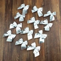 Set of 10 silver satin Christmas bows ornaments displayed on a dark rustic wooden background - OPP Bag 12Pcs / Silver
