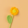 Handmade crochet sunflower bouquet featuring yellow petals and green leaves on orange background - Finished Daisy Branches (yellow)