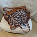 Crossbody leopard print bag with tassel charm and studs on white fleece seat - Brown