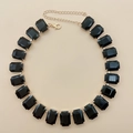 Close-up of black rectangular crystal necklace with gold chain and lobster clasp closure - Black Zirconia