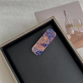 Detailed shot of a rectangular hair clip with blue marble pattern on a leather tray - Map Dark Purple Solid Rectangular